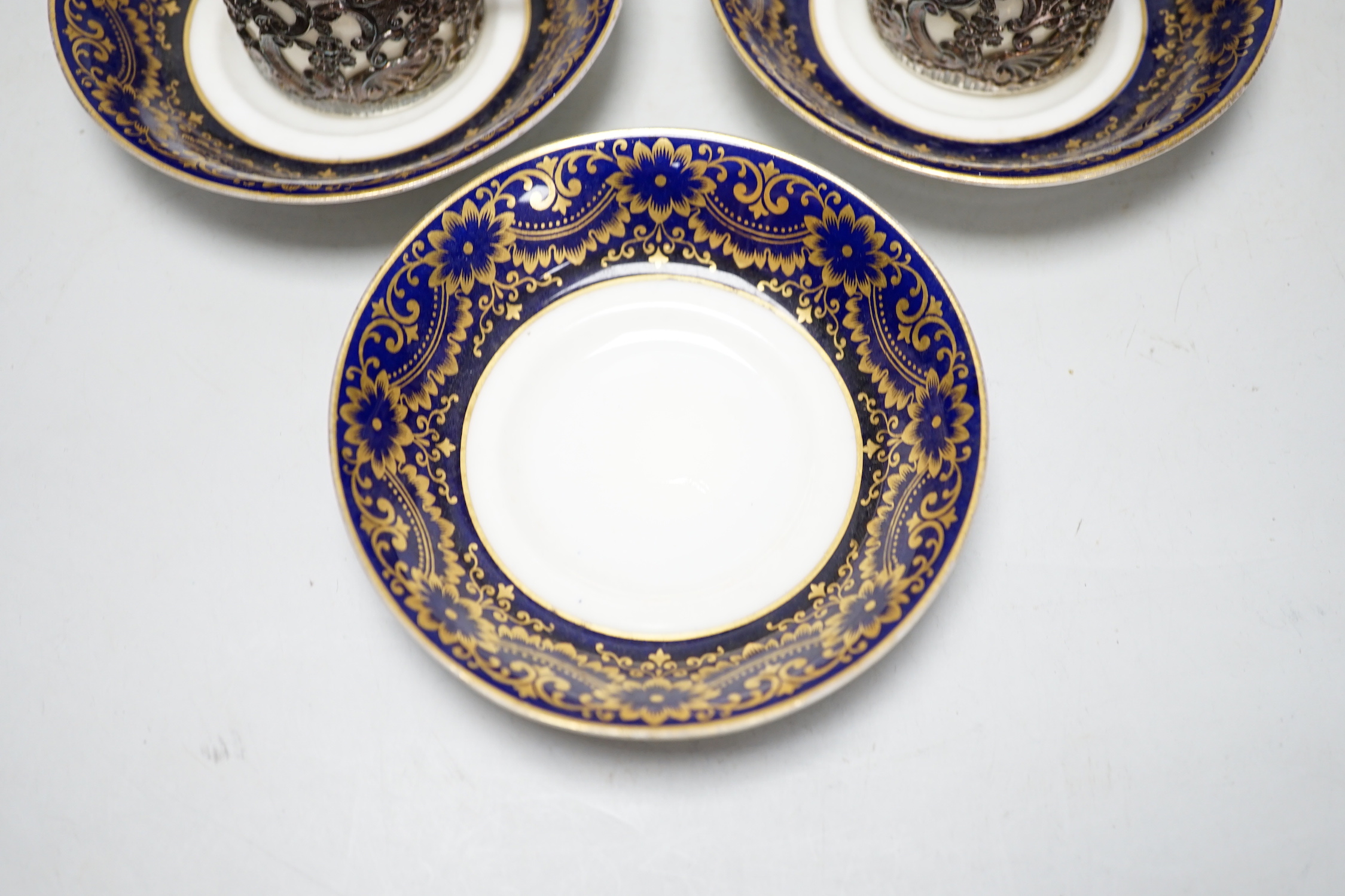 A set of six silver jacketed porcelain cups and saucers